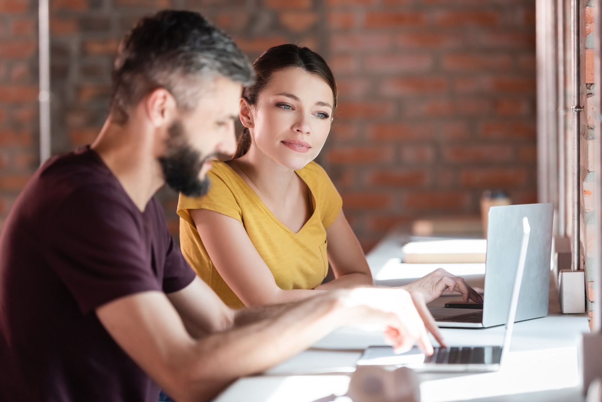 Man and woman working together on a digital skills project